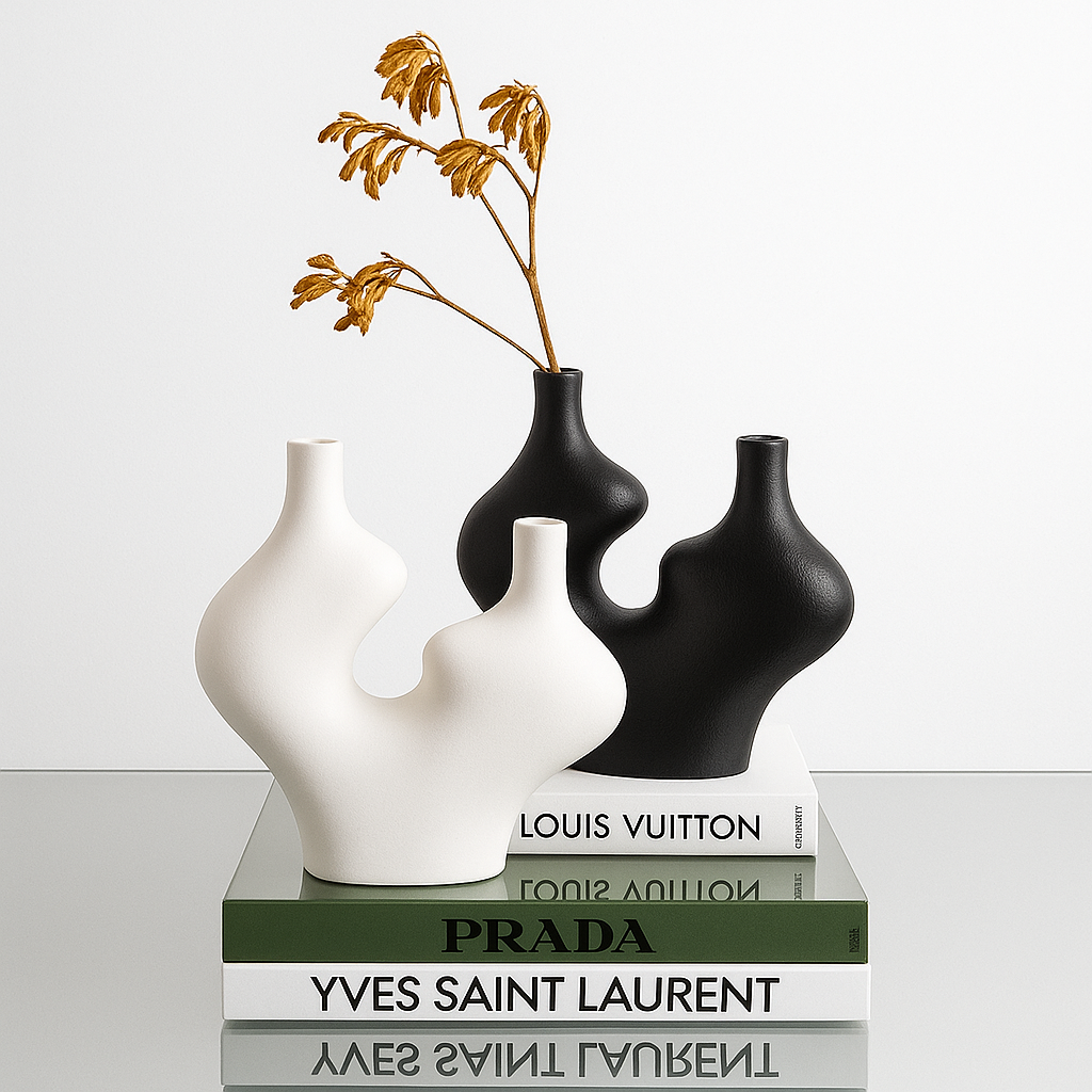 Two vases on top of fashion brand books with a minimal background