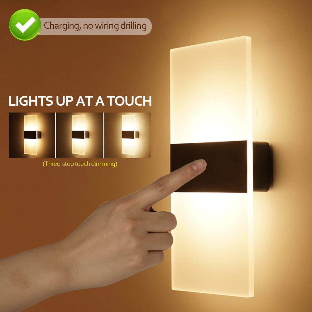 Wall-mounted light fixture with a hand touching it, indicating touch activation.
