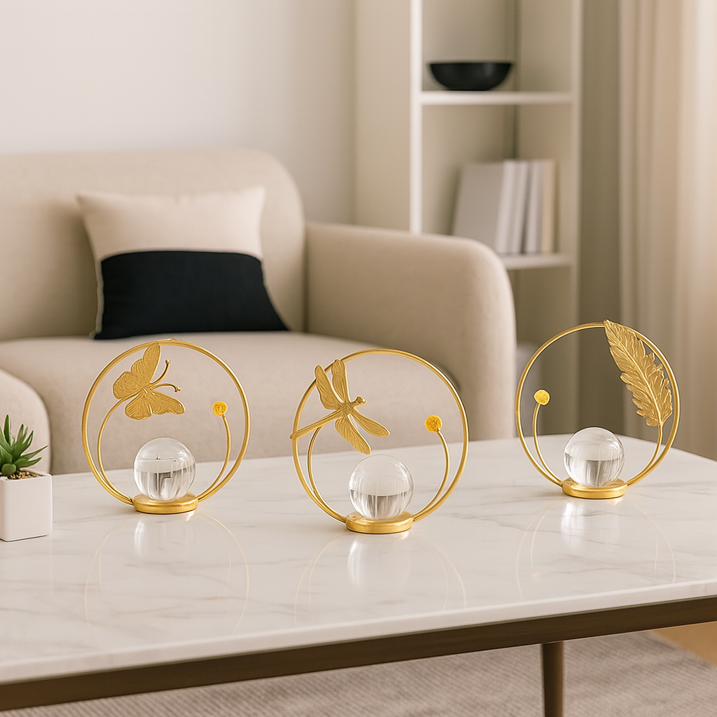 Decorative glass spheres with gold metal frames on a coffee table in a living room setting.