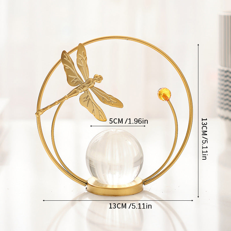 Decorative item with gold dragonfly design and measurements on a white background