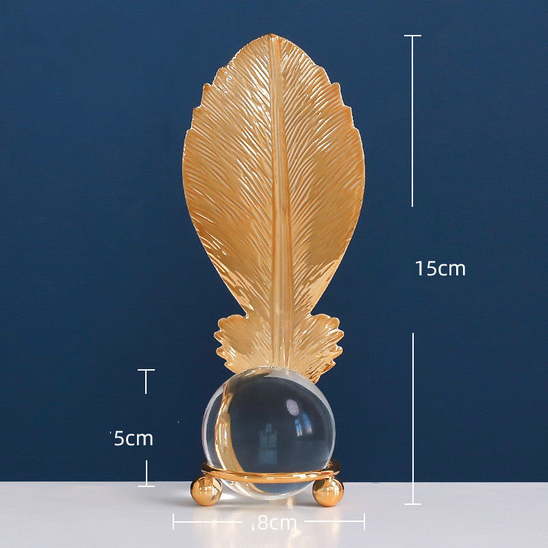 Decorative item with gold leaf and crystal ball on a blue background