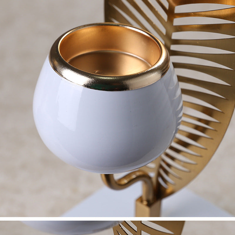 White candle holder with gold rim on a decorative background