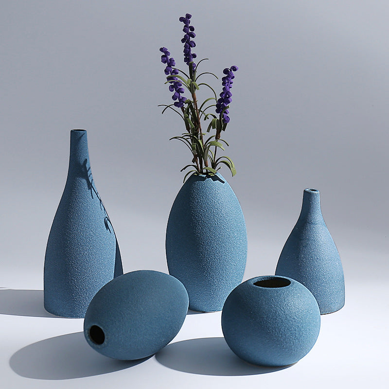 Set of blue textured vases on a light gray background